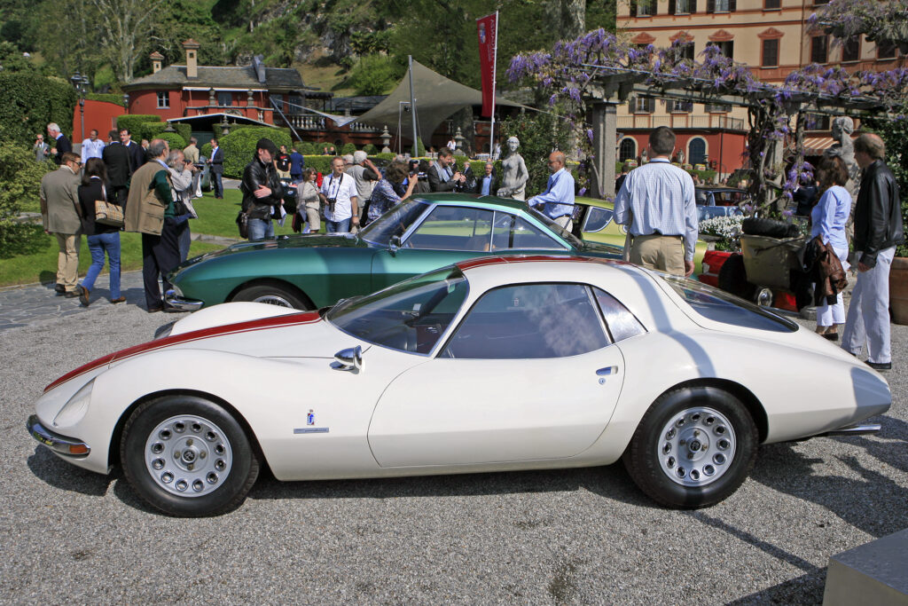 The Alfa Romeo Giulia 1600 TZ2 Coupé Pininfarina 1965 is a legendary machine that epitomizes the pinnacle of Italian engineering and automotive design from the mid-20th century. This sports car features a sleek, aerodynamic profile with fluid curves and bold lines that convey a sense of speed and power. Every detail of the car has been thoughtfully crafted to enhance its performance, handling, and overall driving experience. TZ standing for lughtweight Tubulare Zagato . Concorso d'Eleganza Villa d'Este - 2010