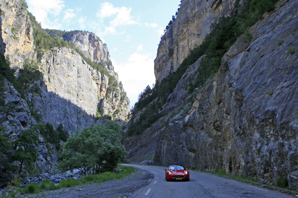 Our must drives nature wonders to add to the Route des Grandes Alpes® #1 A Ferrari California during a loup at the ensational Heights, Lunar Landscapes & Unforgetable Resorts Tour.